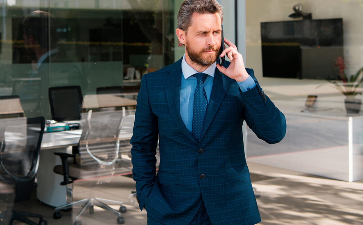 Businessman Talking On Phone. Businessman In Front Office. Hands