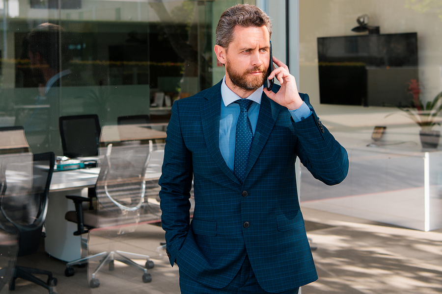 Businessman Talking On Phone. Businessman In Front Office. Hands