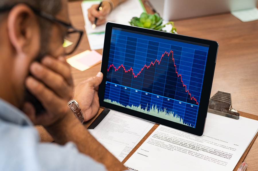 Closeup of a stock market broker working with graphs on digital