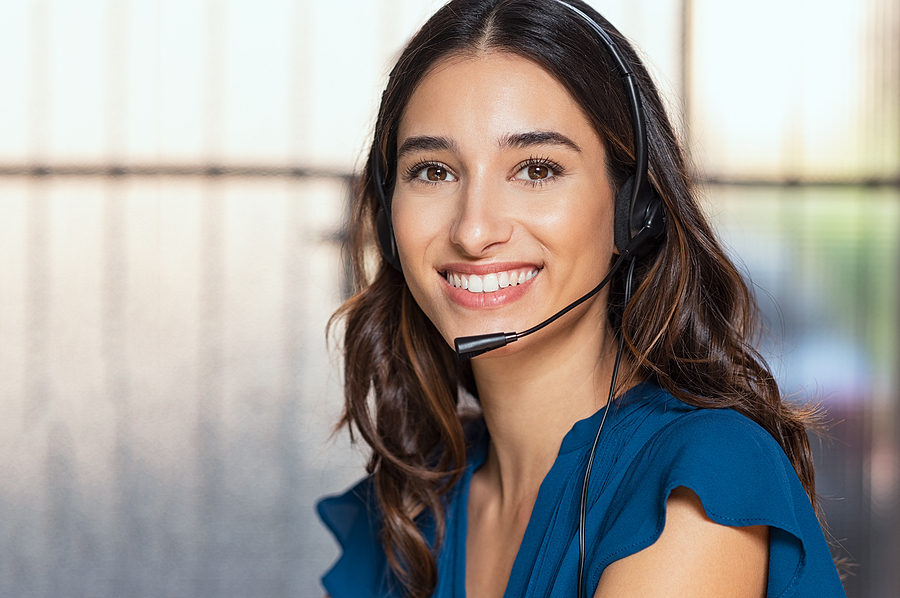 Customer support woman smiling and looking at camera. Portrait o