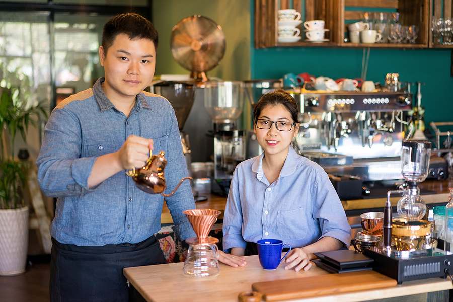 Modern Asian Couple Making Best Coffee In Town. Content Confiden